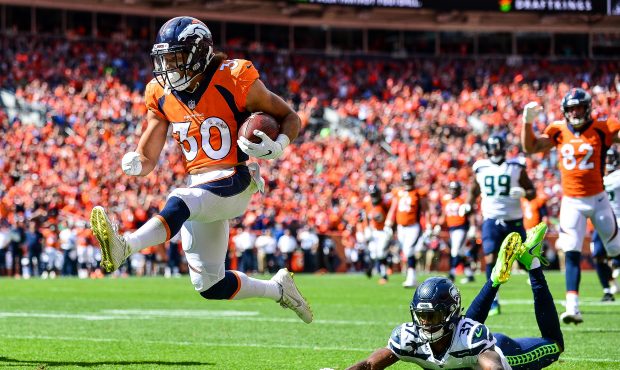Running back Phillip Lindsay #30 of the Denver Broncos scores a first quarter touchdown on a recept...