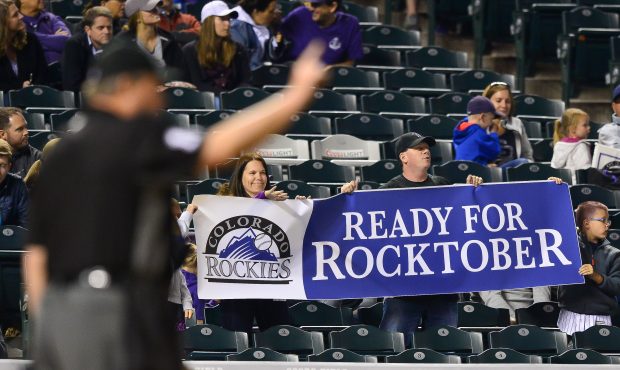 Colorado Rockies fans hold a sign referring to "Rocktober", or a Rockies playoff run, during a game...