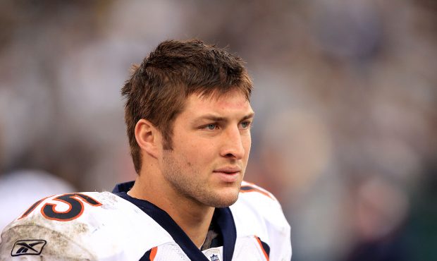Tim Tebow #15 of the Denver Broncos stands on the sideline during their game against the Oakland Ra...