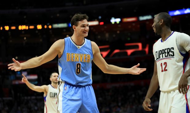 Danilo Gallinari #8 of the Denver Nuggets gestures to Luc Mbah a Moute #12 of the LA Clippers durin...