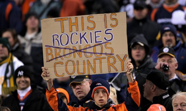 A Denver Broncos fan shows his support of the Colorado Rockies as the Broncos face the Pittsburgh S...