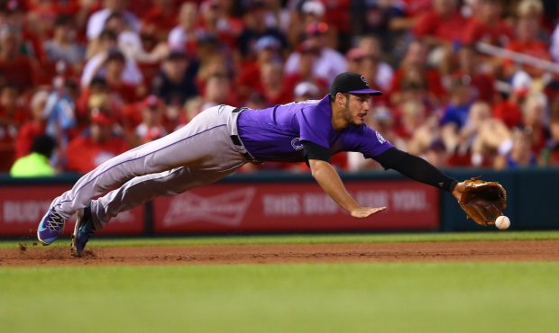 Nolan Arenado #28 of the Colorado Rockies attempts to field a ground ball against the St. Louis Car...