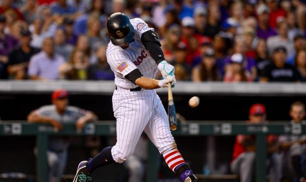 DENVER, CO - JULY 03: Nolan Arenado #28 of the Colorado Rockies hits a seventh inning sacrifice fly...