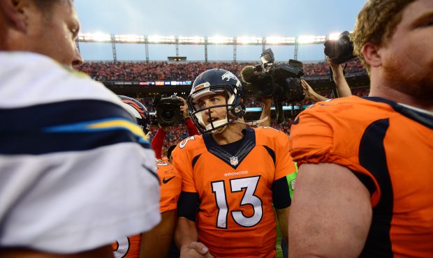 DENVER, CO - OCTOBER 30:  Quarterback Trevor Siemian #13 of the Denver Broncos shakes hands with qu...