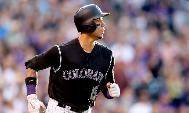DENVER, CO - JUNE 20:  Carlos Gonzalez #5 of the Colorado Rockies circles the bases after hitting a...