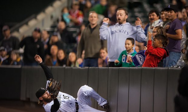 DENVER, CO - SEPTEMBER 05:  Charlie Blackmon #19 of the Colorado Rockies makes a sliding catch in f...