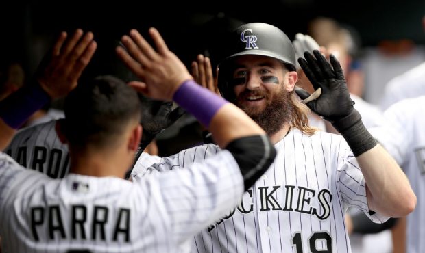 DENVER, CO - JULY 19:  Charlie Blackmon #19 of the Colorado Rockies is congratulated in the dugout ...