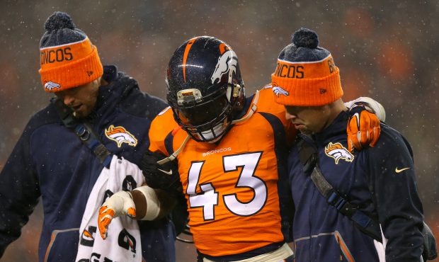 DENVER, CO - NOVEMBER 29: Strong safety T.J. Ward #43 of the Denver Broncos is helped off of the fi...