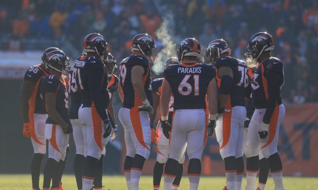 DENVER, CO - DECEMBER 18:  The Denver Broncos offense huddles in the first quarter of a game agains...