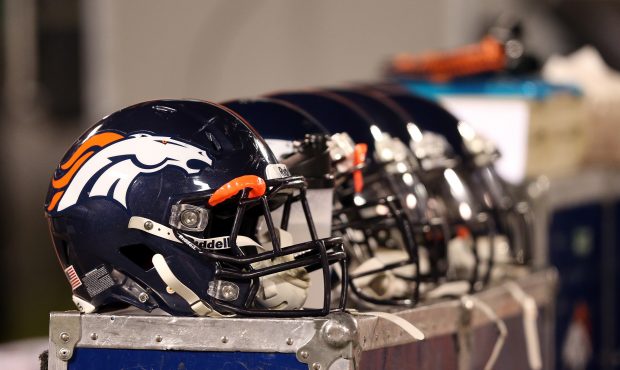 Denver Broncos helmets sit on the bench during their game against the Oakland Raiders at O.co Colis...