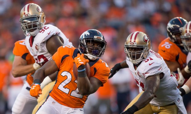 Running back C.J. Anderson #22 of the Denver Broncos gets around inside linebacker Gerald Hodges #5...