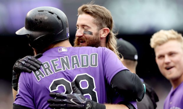 DENVER, CO - AUGUST 03:  Nolan Arenado #28 of the Colorado Rockies is congratulated by Charlie Balc...
