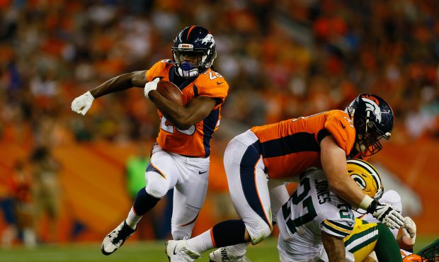 DENVER, CO - AUGUST 26: Running back Jamaal Charles #28 of the Denver Broncos runs with the footbal...