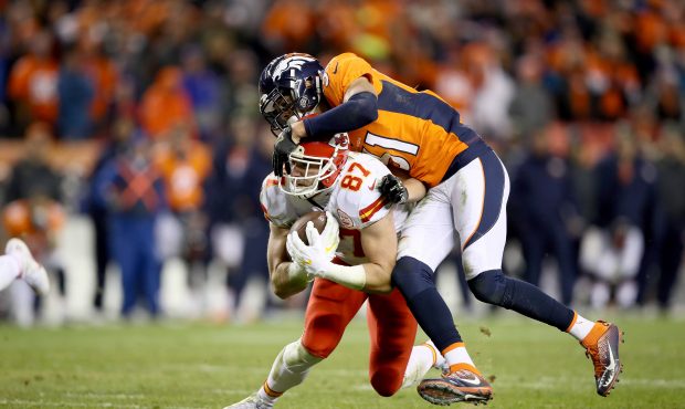 DENVER, CO - NOVEMBER 27:  
Travis Kelce #87 of the Kansas City Chiefs is tackled by Justin Simmons...