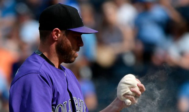KANSAS CITY, MO - AUGUST 24: Greg Holland #56 of the Colorado Rockies uses the rosin bag before thr...