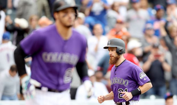 DENVER, CO - AUGUST 03:  Jonathan Lucroy #21 of the Colorado Rockies scores after Nolan Arenado is ...