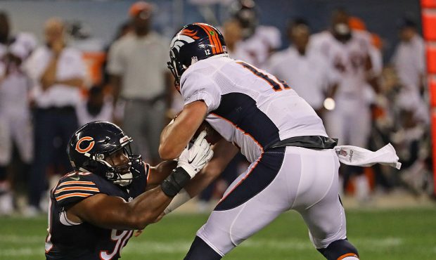 CHICAGO, IL - AUGUST 11: Cornelius Washington #90 of the Chicago Bears sacks  Paxton Lynch #12 of t...