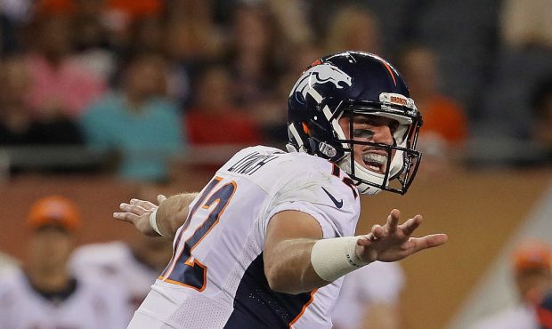 Paxton Lynch #12 of the Denver Broncos calls the signals against the Chicago Bears at Soldier Field...