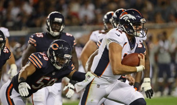 CHICAGO, IL - AUGUST 10:  Paxton Lynch #12 of the Denver Broncos breaks away from Jonathan Anderson...