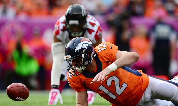 DENVER, CO - OCTOBER 9:  Quarterback Paxton Lynch #12 of the Denver Broncos recovers his own fumble...