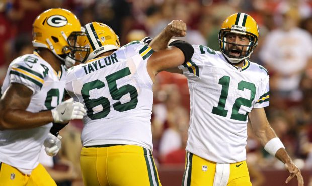 LANDOVER, MD - AUGUST 19: Quarterback Aaron Rodgers #12 of the Green Bay Packers celebrates a touch...