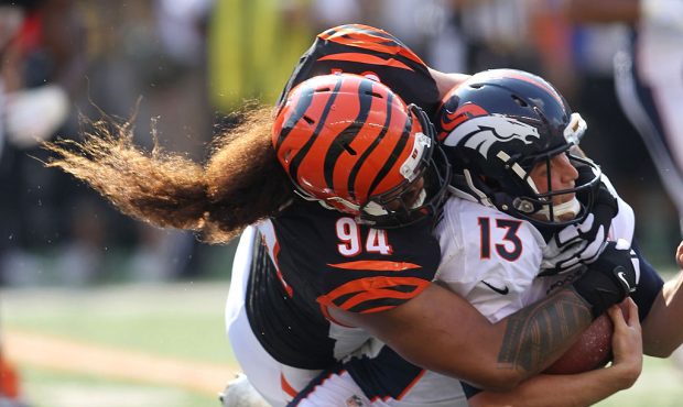 CINCINNATI, OH - SEPTEMBER 25:  Domata Peko #94 of the Cincinnati Bengals sacks Trevor Siemian #13 ...