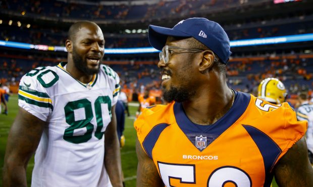 DENVER, CO - AUGUST 26: Outside Linebacker Von Miller #58 of the Denver Broncos shares a laugh with...