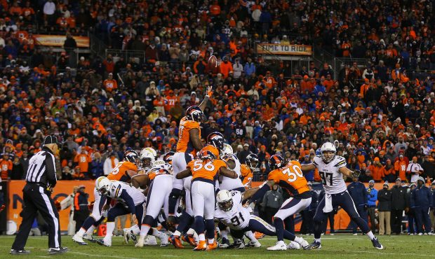 DENVER, CO - JANUARY 12:  Mike Scifres #5 of the San Diego Chargers attempts a fourth quarter field...