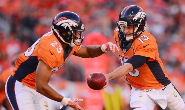 DENVER, CO - SEPTEMBER 18:  Quarterback Trevor Siemian #13 of the Denver Broncos hands the ball off...