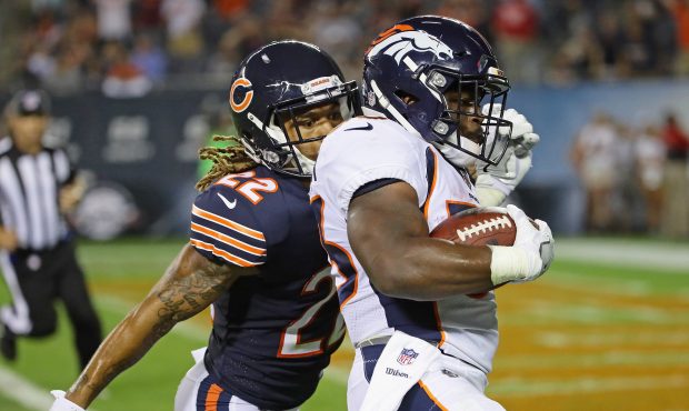 CHICAGO, IL - AUGUST 10:  De'Angelo Henderson #33 of the Denver Broncos runs past Cre'von LeBlanc #...