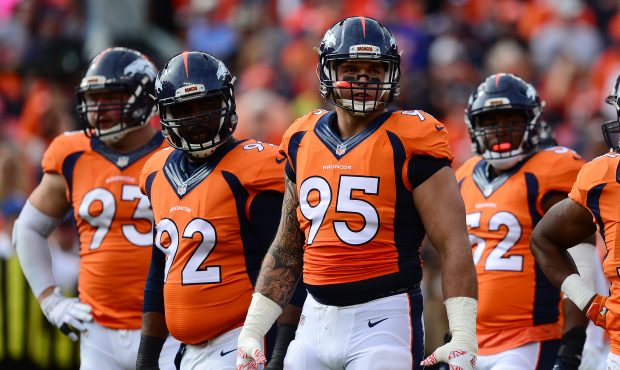 DENVER, CO - OCTOBER 30:  Defensive end Derek Wolfe #95 of the Denver Broncos and other players loo...
