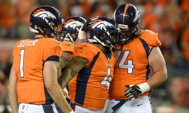 DENVER, CO - AUGUST 31: Running back Stevan Ridley #4 of the Denver Broncos celebrates with Kyle Sl...