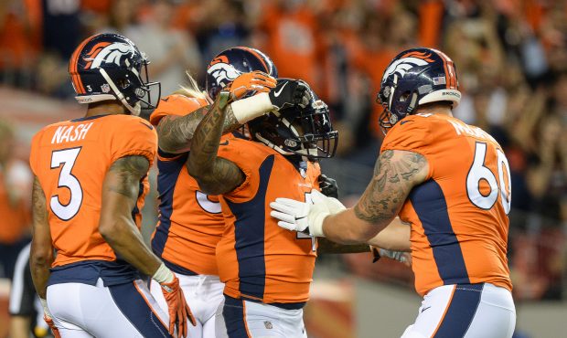 DENVER, CO - AUGUST 31: Running back Stevan Ridley #4 of the Denver Broncos celebrates after scorin...
