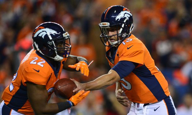 DENVER, CO - SEPTEMBER 11:  Quarterback Trevor Siemian #13 hands the ball off to C.J. Anderson #22 ...