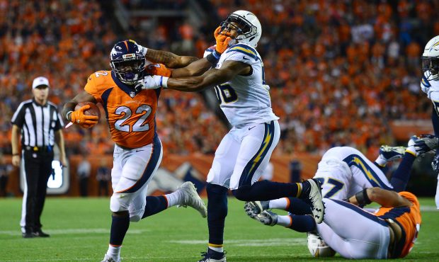 DENVER, CO - SEPTEMBER 11: Running back C.J. Anderson #22 of the Denver Broncos stiff arms inside l...