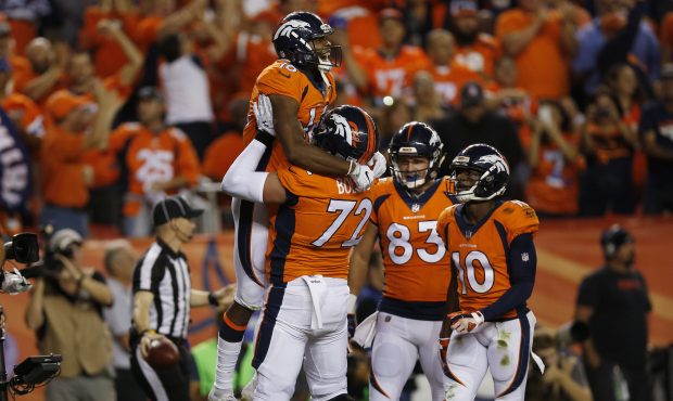 DENVER, CO - SEPTEMBER 11:  Bennie Fowler #16 celebrates a touchdown catch with offensive tackle Ga...