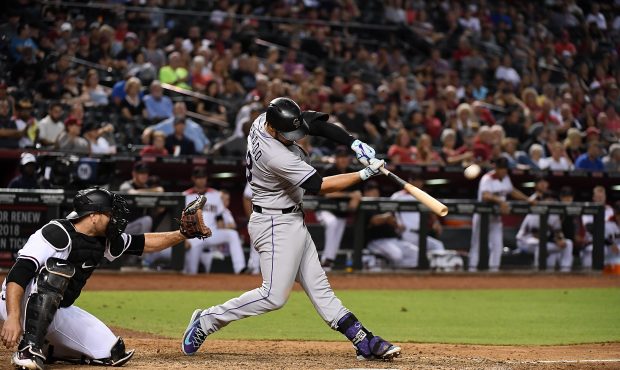 PHOENIX, AZ - SEPTEMBER 11:  Nolan Arenado #28 of the Colorado Rockies hits a three run home run of...