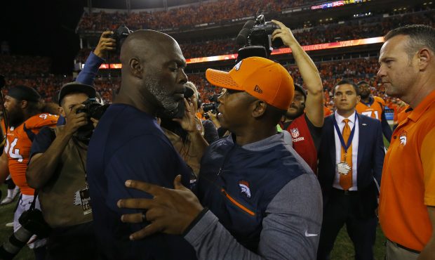 DENVER, CO - SEPTEMBER 11: Head coach Vance Joseph of the Denver Broncos talks with head coach Anth...