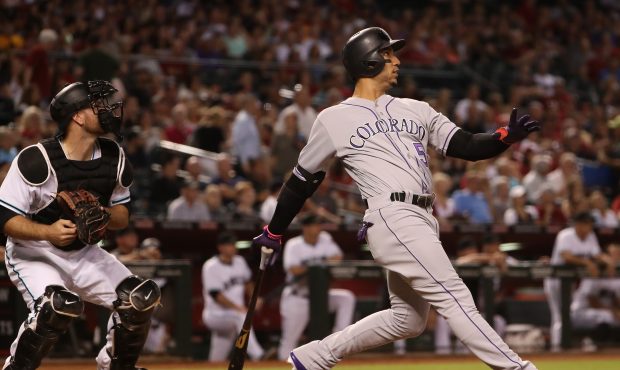 PHOENIX, AZ - SEPTEMBER 12:  Carlos Gonzalez #5 of the Colorado Rockies hits a two run home run aga...