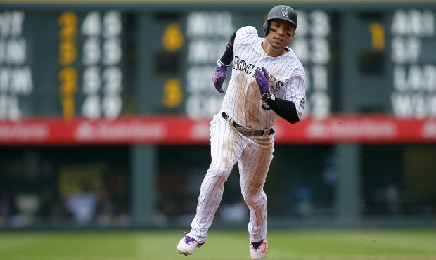 DENVER, CO - SEPTEMBER 17:   Carlos Gonzalez #5 of the Colorado Rockies goes first to third on a Ro...