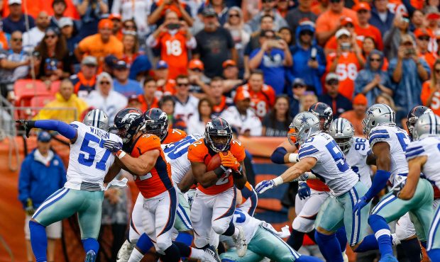 DENVER, CO - SEPTEMBER 17: Running back C.J. Anderson #22 of the Denver Broncos rushes against the ...