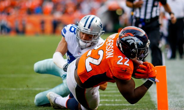 DENVER, CO - SEPTEMBER 17: Running back C.J. Anderson #22 of the Denver Broncos rushes past strong ...