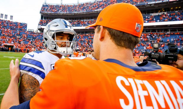 DENVER, CO - SEPTEMBER 17:  Quarterback Trevor Siemian #13 of the Denver Broncos and quarterback Da...
