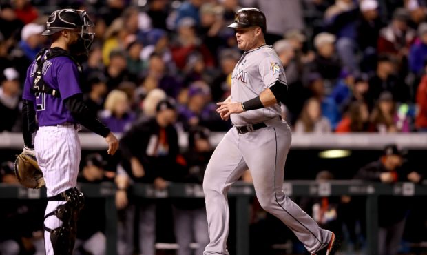 DENVER, CO - SEPTEMBER 25:  Justin Bour #41 of the Miami Marlins scores on a Miguel Rojas 3 RBI dou...
