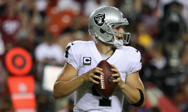 LANDOVER, MD - SEPTEMBER 24: Quarterback Derek Carr #4 of the Oakland Raiders drops back to pass ag...