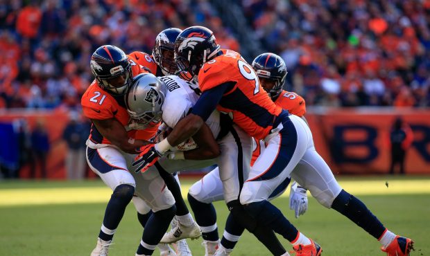 DENVER, CO - DECEMBER 28:  Wide receiver Brice Butler #12 of the Oakland Raiders is tackled by corn...