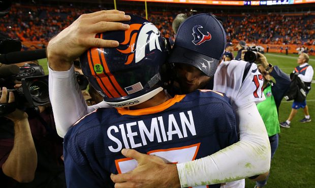DENVER, CO - OCTOBER 24:  Quarterback Brock Osweiler #17 of the Houston Texans hugs quarterback Tre...