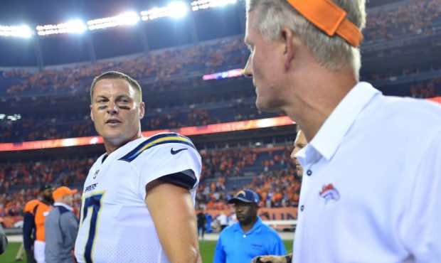 DENVER, CO - SEPTEMBER 11:  Quarterback Philip Rivers #17 of the Los Angeles Chargers talks with hi...