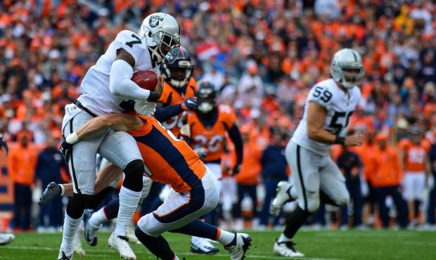 DENVER, CO - OCTOBER 1:  Punter Marquette King #7 of the Oakland Raiders carries the ball on a fake...