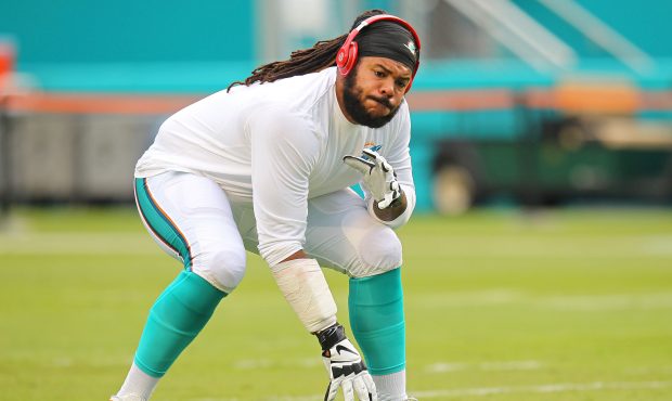 Billy Turner of the Miami Dolphins warms up before the game against the Dallas Cowboys at Sun Life ...